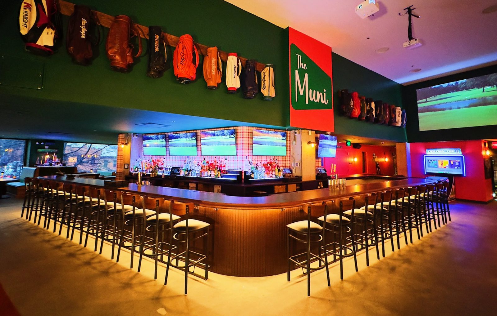 The Muni's main bar with golf simulator screens overhead