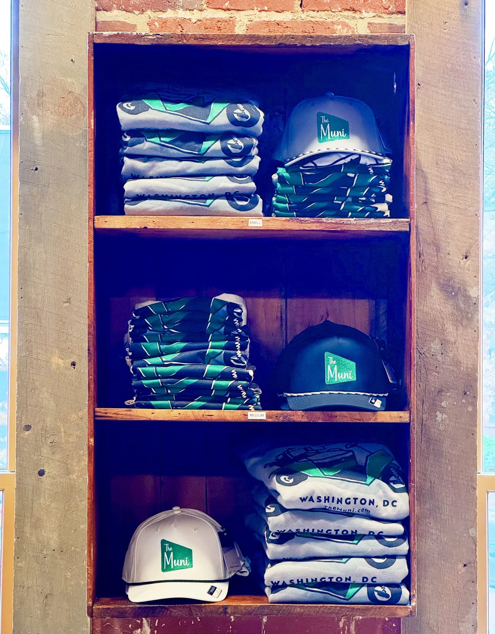Shelves of The Muni tees and hats in the pro shop